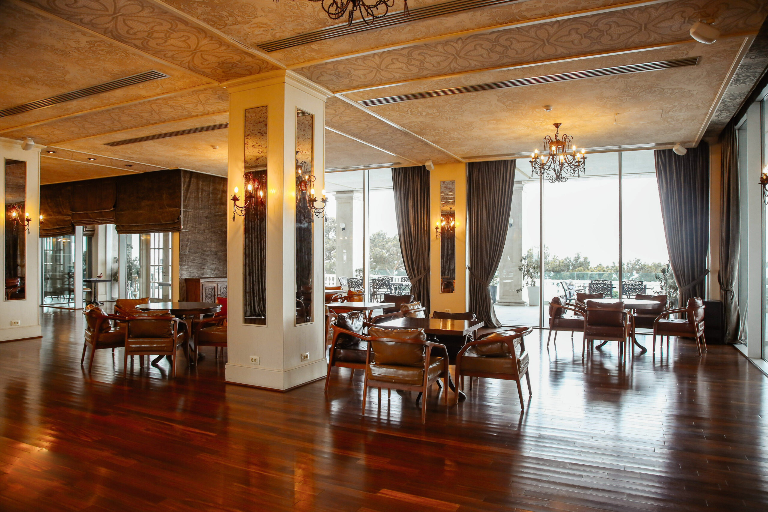 restaurant hall with leather armchairs and french windows